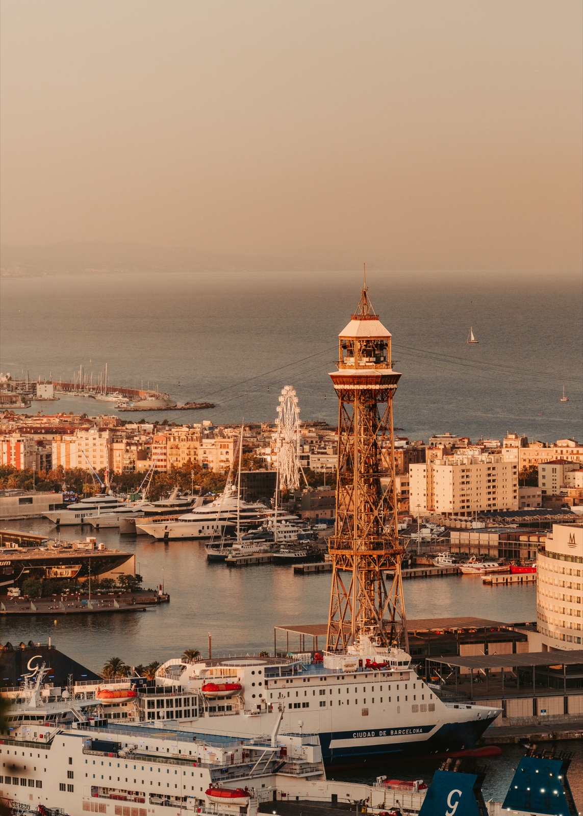 A cable car tower above the port, with the sea behind