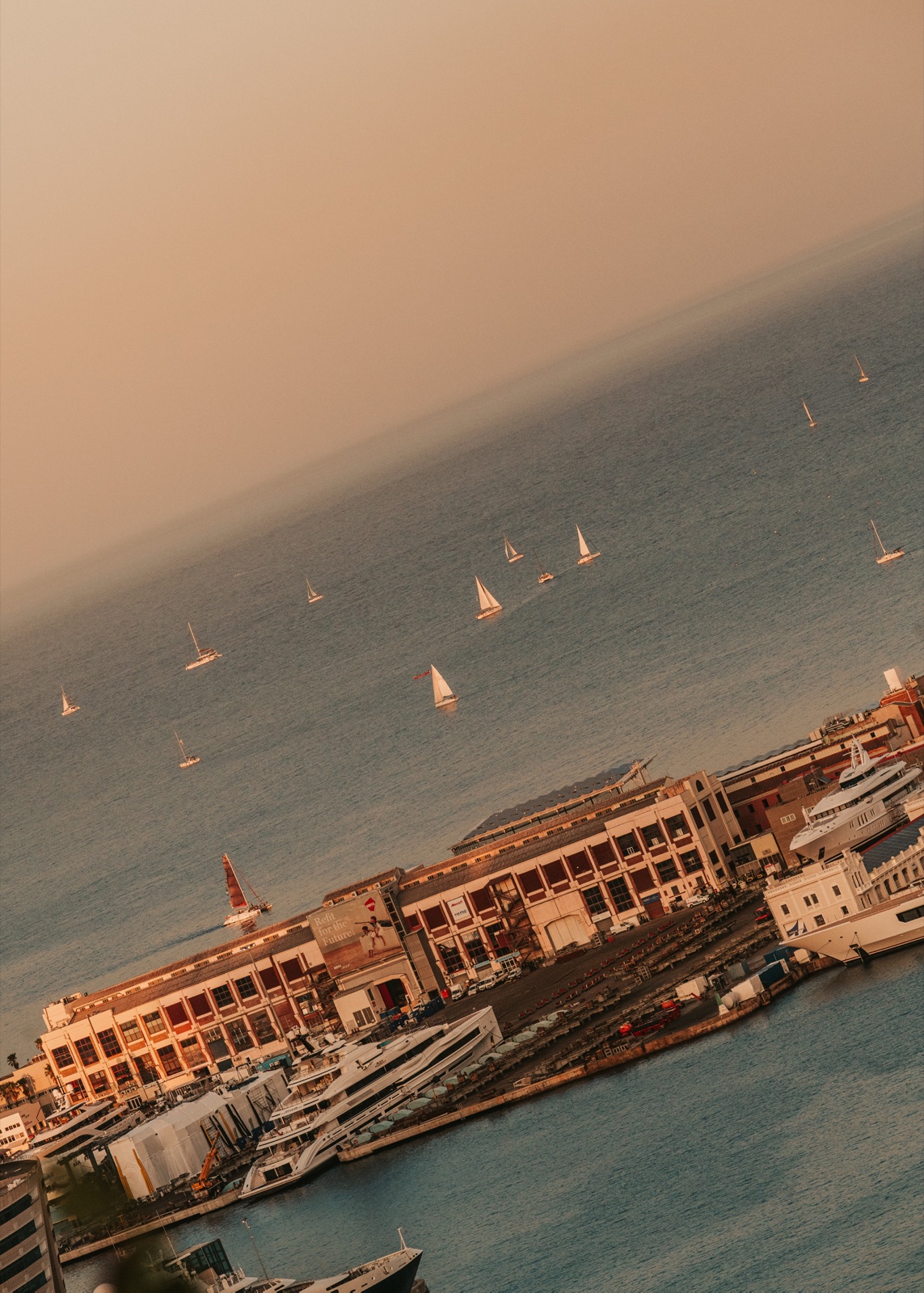 Sailing boats on the sea beyond Barcelona’s port